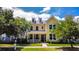 Charming two-story yellow home with dormer windows and a welcoming front porch at 157 Village Ponds Dr, Summerville, SC 29483