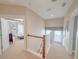 Bright hallway with wood railing leads to a Primary bedroom with abundant natural light and stylish decor at 157 Village Ponds Dr, Summerville, SC 29483