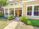 Inviting front porch with white railing and lush landscaping details at 157 Village Ponds Dr, Summerville, SC 29483