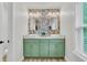 Stylish bathroom featuring a double sink vanity, modern fixtures, and eye-catching floral wallpaper at 1576 Nautical Chart Dr, Charleston, SC 29414