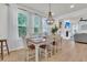 Elegant dining room with a chandelier, ample natural light, and hardwood floors at 1576 Nautical Chart Dr, Charleston, SC 29414