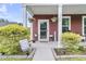 Inviting front entrance with a decorative wreath, hanging plants, and well-manicured landscaping at 1576 Nautical Chart Dr, Charleston, SC 29414