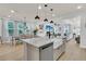 Bright open kitchen with a view of the adjacent dining area, large windows and an expansive island at 1576 Nautical Chart Dr, Charleston, SC 29414