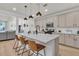 An open kitchen features a marble island with seating and sleek stainless steel appliances at 1576 Nautical Chart Dr, Charleston, SC 29414