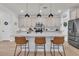 A kitchen island with marble countertop, stainless steel appliances, and modern lighting with seating for three at 1576 Nautical Chart Dr, Charleston, SC 29414