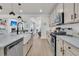 Open concept kitchen with stainless steel appliances and large island sink overlooking living area at 1576 Nautical Chart Dr, Charleston, SC 29414