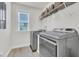 Modern laundry room features updated machines, built in shelving and a bright window at 1576 Nautical Chart Dr, Charleston, SC 29414