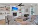 Comfortable living room with a fireplace, built-in shelving, and a large sectional sofa at 1576 Nautical Chart Dr, Charleston, SC 29414