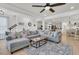 Open-concept living area with hardwood floors, comfortable sectional sofa, and view to the kitchen at 1576 Nautical Chart Dr, Charleston, SC 29414
