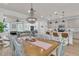 Open-concept floor plan showcasing a dining room and living room with abundant natural light and a decorative chandelier at 1576 Nautical Chart Dr, Charleston, SC 29414