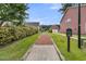 Nature trail with a charming walkway leading to the garage of a home in a peaceful community at 1576 Nautical Chart Dr, Charleston, SC 29414