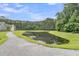 Scenic view of a community pond, reflecting the sky and trees, with a gravel path alongside it at 1576 Nautical Chart Dr, Charleston, SC 29414