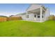 Spacious backyard with healthy green grass, wooden fence, and covered patio at 158 Hayworth Rd, Summerville, SC 29486