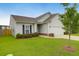 Attractive home with a manicured lawn, a young tree, and a driveway leading to an attached garage at 158 Hayworth Rd, Summerville, SC 29486