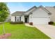 Well-maintained single-Gathering home with green lawn, trimmed bushes, and a driveway leading to the garage at 158 Hayworth Rd, Summerville, SC 29486