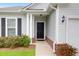 Inviting entryway with a black front door, brick accents, manicured bushes, and a charming overhead light at 158 Hayworth Rd, Summerville, SC 29486