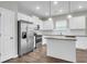 Modern kitchen with stainless steel appliances, white cabinetry, a granite island, and hardwood floors at 158 Hayworth Rd, Summerville, SC 29486