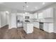 Bright kitchen featuring stainless steel appliances, white cabinetry, a granite island, and hardwood floors at 158 Hayworth Rd, Summerville, SC 29486