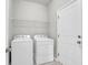 Bright laundry room features a washer, dryer, wire shelf, and door at 158 Hayworth Rd, Summerville, SC 29486
