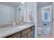 Charming bathroom featuring a granite countertop vanity, sink, and an open doorway to an adjacent room at 1607 Waterside Blvd, Moncks Corner, SC 29461