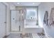 Clean bathroom with a walk-in shower, soaking tub, and decorative towels at 1607 Waterside Blvd, Moncks Corner, SC 29461