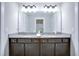 Bathroom featuring a granite countertop double vanity, large mirror, and soft lighting at 1607 Waterside Blvd, Moncks Corner, SC 29461