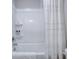 Well-lit bathroom featuring a shower-tub combination and a neutral shower curtain at 1607 Waterside Blvd, Moncks Corner, SC 29461