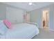 Bright bedroom showcasing a white bed frame, plush pillows, and a doorway leading to an adjoining bathroom at 1607 Waterside Blvd, Moncks Corner, SC 29461