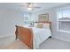 Comfortable bedroom featuring a wooden bed frame, soft carpeting, and natural light from the windows at 1607 Waterside Blvd, Moncks Corner, SC 29461