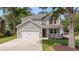 Charming two-story home with a well-manicured lawn, front porch, and two-car garage at 1607 Waterside Blvd, Moncks Corner, SC 29461