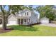 Charming two-story home with a well-manicured lawn and inviting front porch at 1607 Waterside Blvd, Moncks Corner, SC 29461