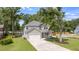 Charming two-story home with a well-manicured lawn and long private driveway at 1607 Waterside Blvd, Moncks Corner, SC 29461
