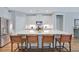 Modern kitchen island with seating, stainless steel appliances, and white cabinetry at 1607 Waterside Blvd, Moncks Corner, SC 29461