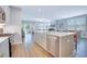 Open-concept kitchen with island, stainless steel appliances, and hardwood floors at 1607 Waterside Blvd, Moncks Corner, SC 29461
