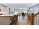 Open-concept living area with a stylish kitchen island, dining area, and cozy fireplace, perfect for entertaining at 1607 Waterside Blvd, Moncks Corner, SC 29461