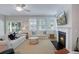 Bright living room features a fireplace, ceiling fan, and sliding glass door to the outside at 1607 Waterside Blvd, Moncks Corner, SC 29461
