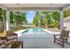 Stunning pool view surrounded by lush trees and lake, seen from covered outdoor living space at 1607 Waterside Blvd, Moncks Corner, SC 29461