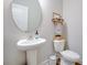 Practical powder room featuring a pedestal sink, toilet, and decorative shelving at 1607 Waterside Blvd, Moncks Corner, SC 29461