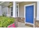 Inviting entryway with a vibrant blue front door, stone accents, and a covered porch at 1634 Eider Down Dr, Summerville, SC 29483