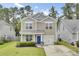 Charming two-story home with a manicured lawn, a blue front door, and attached one car garage at 1634 Eider Down Dr, Summerville, SC 29483