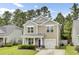 Charming two-story home with a manicured lawn, a blue front door, and attached one car garage at 1634 Eider Down Dr, Summerville, SC 29483