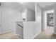Upstairs hallway showcasing neutral paint, carpet, and an open doorway to another room at 1634 Eider Down Dr, Summerville, SC 29483