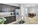 Bright kitchen featuring granite countertops, stainless steel appliances, and dark cabinets at 1634 Eider Down Dr, Summerville, SC 29483