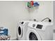 Bright laundry room equipped with modern, front-load washer and dryer units for efficient laundry care at 1634 Eider Down Dr, Summerville, SC 29483