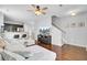 Open living room with hardwood floors, a plush sectional sofa, dark-stained cabinets, and a staircase at 1634 Eider Down Dr, Summerville, SC 29483