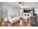 Open living room with hardwood floors, a plush sectional sofa, and dark-stained cabinets at 1634 Eider Down Dr, Summerville, SC 29483