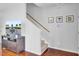 Open living room with staircase, wood floors, and a TV with a fountain displayed at 1634 Eider Down Dr, Summerville, SC 29483