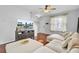 Open living room with hardwood floors, a plush sectional sofa, dark-stained cabinets, and a staircase at 1634 Eider Down Dr, Summerville, SC 29483