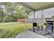 Cozy screened-in patio with outdoor seating, overlooking a fenced backyard at 1634 Eider Down Dr, Summerville, SC 29483