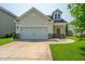 Charming home showcasing an attached garage, a welcoming front door, and well-maintained landscaping at 1689 Eider Down Dr, Summerville, SC 29483